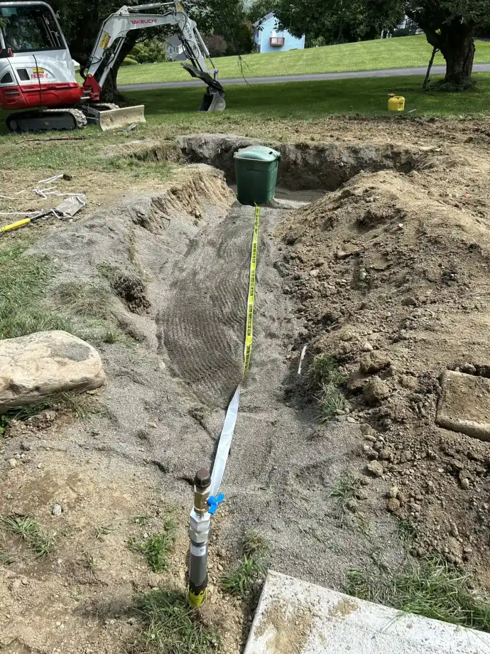 Drainage pipe being installed in trench